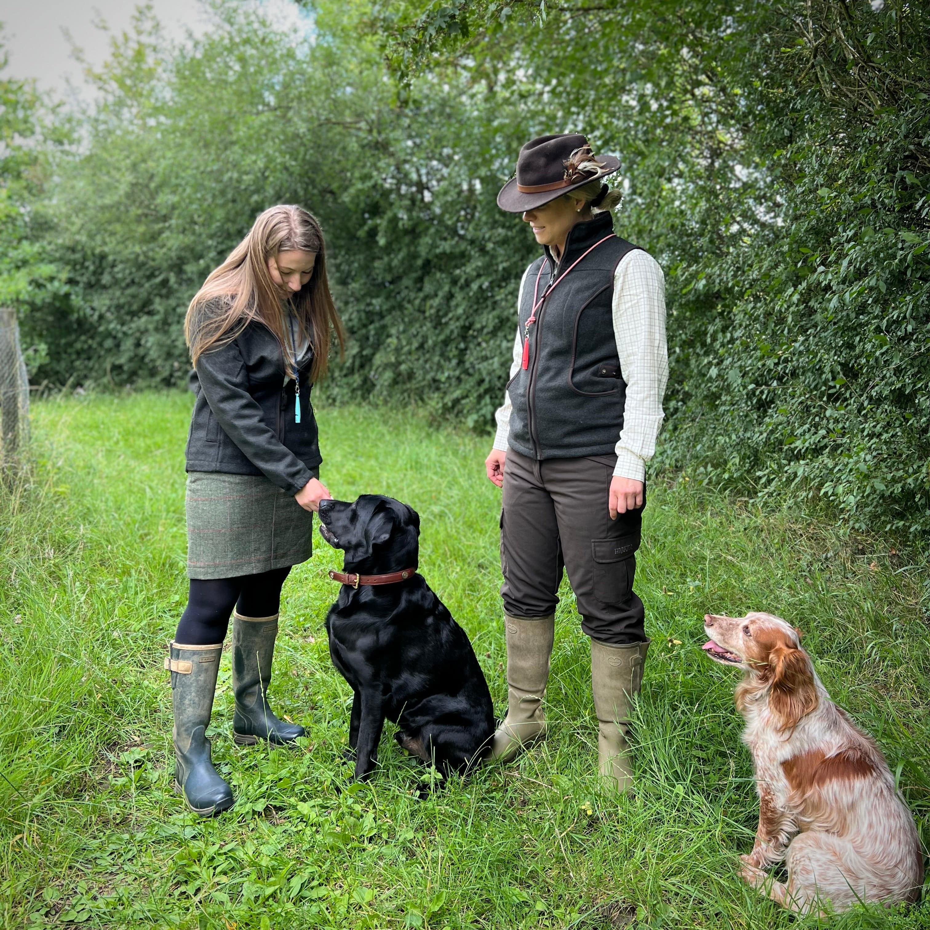 Two women training their gundogs
