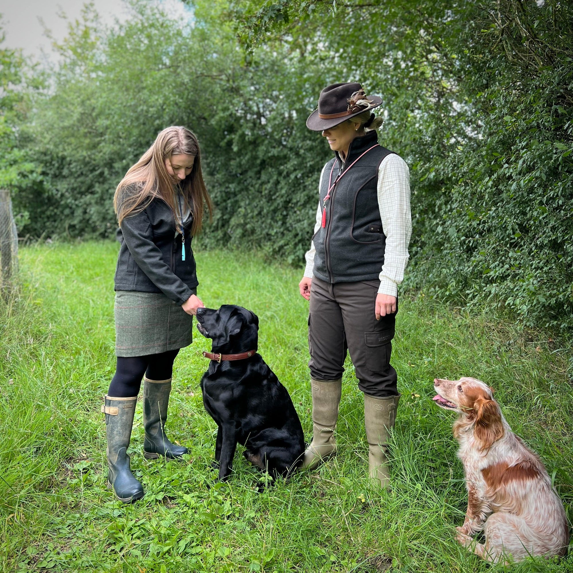 Two women training their gundogs 